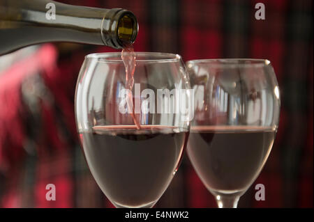 Studioaufnahme strömenden Rotwein in Weingläser Stockfoto