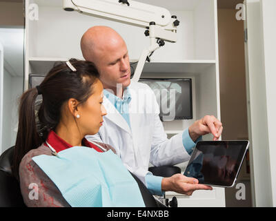 Zahnarzt mit digital-Tablette mit Patientin x-ray Stockfoto