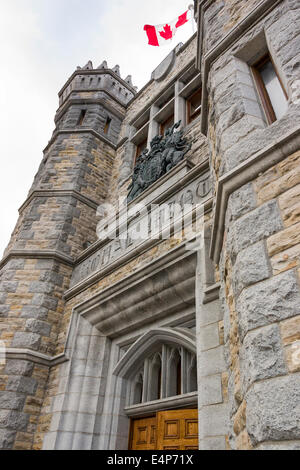 Königliche Minze-Eingang. Der Haupteingang der alten Royal Mint auf Sussex Antrieb.  Eine kanadische Flagge weht über ein Wappen. Stockfoto