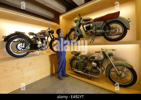 Einbeck, Deutschland. 15. Juli 2014. Kuratorin der Sammlung "Einbecker Kulturstiftung Kornhaus", Andy Schwietzer, steht zwischen den Motorrädern "Mars Stella 175 S" (1956, L), "Victoria Bergmeister" (1955, über R) und "Horex Regina" (1954, unter R) in der PS-Speicher-Ausstellungshalle in Einbeck, Deutschland, 15. Juli 2014. Die Ausstellung "Raeder, Die Uns Bewegen" (lit.-Räder, die uns bewegen) öffnet am 23. Juli 2014. Foto: Swen Pfoertner/Dpa/Alamy Live News Stockfoto