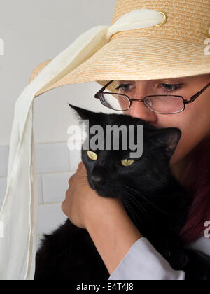 Katze Schwarz mit Mädchen Stockfoto