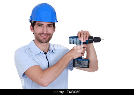 Unrasiert Arbeiter mit Bohrmaschine Stockfoto