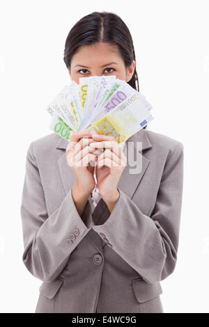 Geschäftsfrau Versteck Gesicht hinter Geld Stockfoto