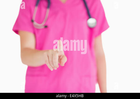 Arzt in rosa scheuert auf etwas gerichtet Stockfoto