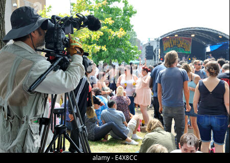 Mann Dreharbeiten Musikbühne mit einer Canon Eos Kamera an Bristol St Pauls Straßenfest, UK Stockfoto