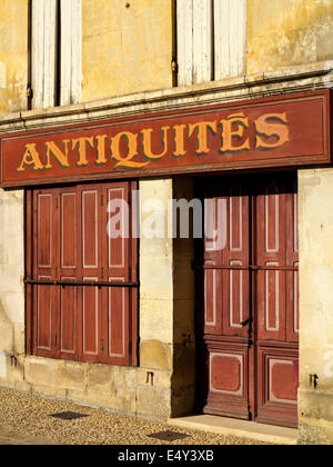 Fensterläden Türen und Fenster auf ein Antiquitätenladen in Pons Süd-west Frankreich mit Antiquitäten Schild gemalt über windows Stockfoto