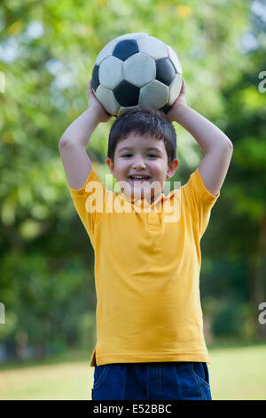 Porträt eines jungen Mannes mit einem Fußball Stockfoto