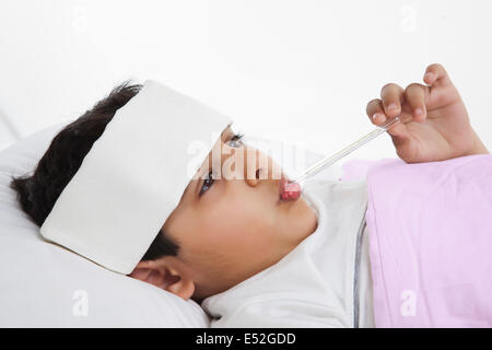 Kleiner Junge mit Thermometer in den Mund Stockfoto