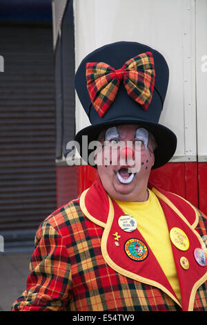 Professionelle Zirkusclown, Spaß, lustig, glücklich, Karneval, Party, Kostüm, Humor, Unterhaltung, Feier, rotes Gesicht, Comic, bunt, Charakter, Kunst, Perücke. Clowning in einem lustigen Top hat und Tartan Anzug in Fleetwood, Lancashire. Performer Paul Davies Ausdrücke von Traurigkeit, Überraschung & Humor. Bunte Clown Kostüm & Art Deco Hut und Kinder Entertainer auf dem Festival of Transport, Großbritannien Stockfoto