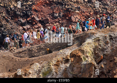 Touristen auf den Rand des Kraters aktiven Nea ("neu") Kameni Insel, im Herzen der Caldera von Santorin. Stockfoto