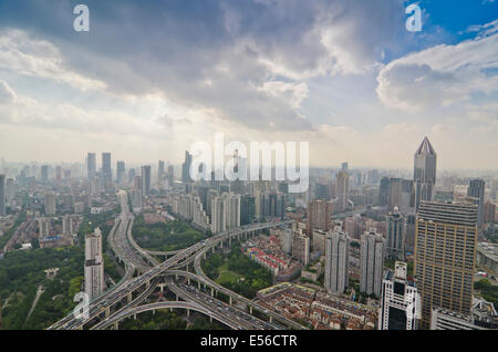 Panoramablick auf den Nachmittagsverkehr während der Hauptverkehrszeit auf dem Yanan-Expressweg, der sich an einem ungewöhnlich klaren, flauschigen wolkenlosen Tag an der Skyline von Westschanghai kreuzt. Stockfoto