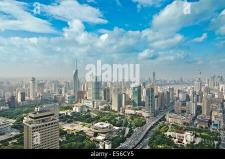 Aerial panoramic view of the skyline Shanghai that includes the Bund and a variety of skyscrapers and highrises such as  residential and office towers on a nice day with fluffy clouds in a blue sky. Stock Photo