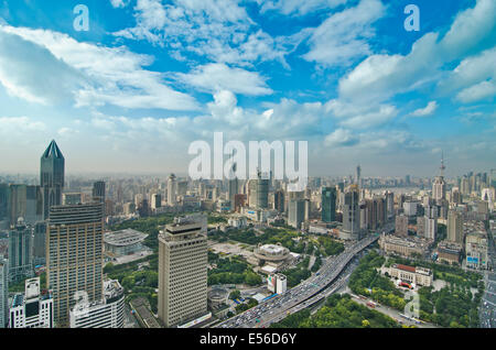 Aerial panoramic view of the skyline Shanghai that includes the Bund and a variety of skyscrapers and highrises such as  residential and office towers on a nice day with fluffy clouds in a blue sky. Stock Photo