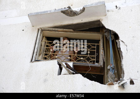 Gaza Stadt, Westjordanland, Gaza-Streifen. 22. Juli 2014. Man sieht durch sein beschädigtes Fenster der benachbarten Moschee durch israelische Luftangriffe zerstört wurde. Die Al-Aqsa-Märtyrer-Moschee in Al Daraj Nachbarschaft in Gaza-Stadt wurde zweimal von Drohnen getroffen; dann einmal M16 letzte Nacht; Niemand wurde verletzt oder getötet, aber die umliegenden Gebäude wurden teilweise beschädigt. Bildnachweis: Eloise Bollack/ZUMA Draht/Alamy Live-Nachrichten Stockfoto