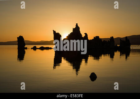 Sonnenaufgang am Mono Lake Tufa Türmen mit goldenen Himmel und Spiegelung im Wasser Stockfoto