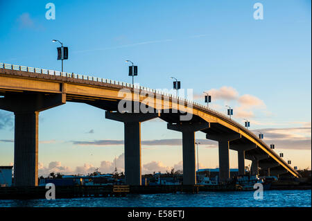 Kurvige Brücke über die Bucht bei Sonnenuntergang Stockfoto