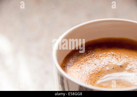 Eine Tasse frisch gebrühten Kaffee in einem Becher auf der Küchenseite Stockfoto