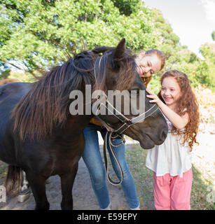 Mutter und Tochter Petting Pferd im freien Stockfoto