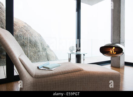Stuhl und Kamin im modernen Wohnzimmer Stockfoto