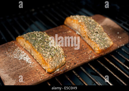 Ein paar gut gewürzt wild Alaskan Lachs-Filets auf einer Zeder Planke gegrillt. Stockfoto