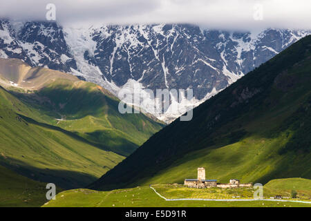 Lamaria Kirche und Turm im großen Kaukasus Hintergrund. Ushguli, dem höchstgelegenen ganzjährig bewohnten Dorf in Europa. Stockfoto