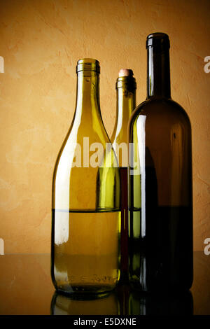 Stillleben mit drei Flaschen Wein über strukturierten Hintergrund Stockfoto