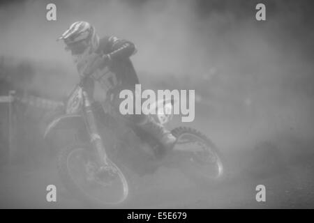 Motocross-Fahrer im Rennen auf staubigen Feldweg in schwarz / weiß Stockfoto