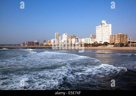 DURBAN, Südafrika - 23. Juli 2014: am frühen Morgen Blick auf Meer und leeren Strand gegen die Skyline der Stadt in Durban, Südafrika Stockfoto