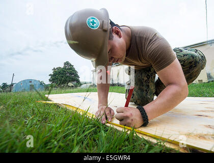 U.S. Navy Bau Mechaniker Seemann James Carney, Bau-Bataillon Wartungseinheit 202, markiert ein Stück Holz wh Stockfoto