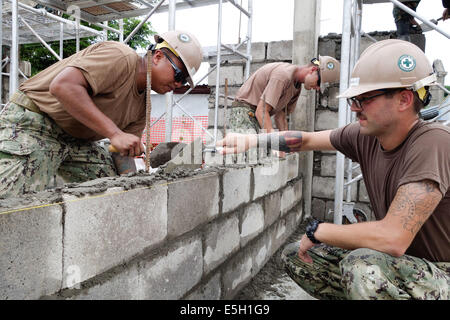 US Marine Equipment Operator 3. Klasse Eduardo Ellorin, links, und Stahlarbeiter Constructionman Cory Migneault verbreiten Mörtel Whil Stockfoto