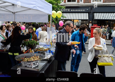 Mitglieder der Öffentlichkeit Thai Essen kaufte von einem Imbissstand Marylebone Street Sommer Fayre fair Festival, London, UK. Stockfoto