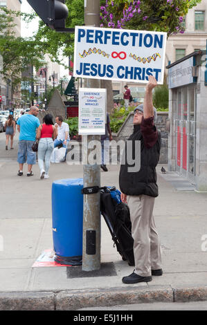 Straßenprediger mit einem Schild in der Innenstadt von Montreal, Québec, Kanada. Stockfoto