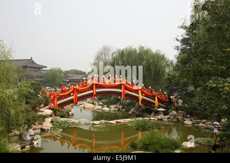 Xi ' an, China. 2. August 2014. Paare posieren für ein Gruppenfoto auf der Bogenbrücke über Huaqing Pool in Xi ' an, Hauptstadt der Nordwesten der chinesischen Provinz Shaanxi, 2. August 2014. Das Qixi-fest, entstammt auch bekannt als chinesischer Valentinstag, die am 2. August dieses Jahres fällt, einem Volksmärchen über eine Fee falling in Love mit einem Sterblichen. Die Ehe angeblich erzürnte die Göttin des Himmels, wer die Milchstraße erstellt, sie zu trennen. Bildnachweis: Xinhua/Alamy Live-Nachrichten Stockfoto