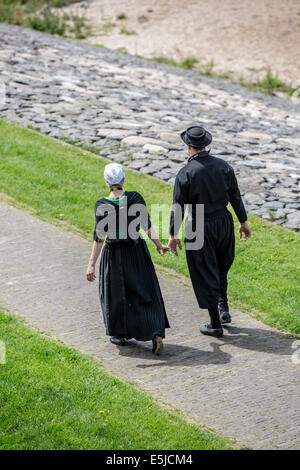 Niederlande, Urk, Mann und Frau im traditionellen Sonntag Kleid am Deich Stockfoto