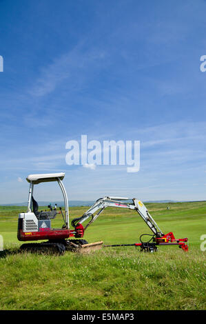 Graben Maschine, Golfclub Royal Porthcawl, South Wales, UK. Stockfoto