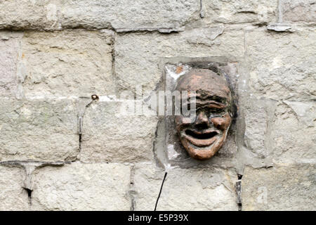 Leiter der ein Wasserspeier an einer Wandseite Stockfoto