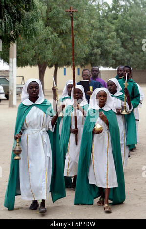 Altar-Mädchen mit Kerzen, die Sie fortfahren, um einen Gottesdienst in der katholischen St. Timotheus Kirche in Maiduguri, Nigeria Stockfoto