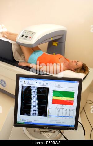 Ein Arzt benutzt ein Knochen Densitometer zur Messung der optischen Dichte der unteren Rachis (Backbone) der Patientin zu diagnostizieren Stockfoto