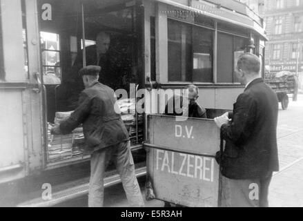 Das Bild aus einem Nazi-Nachrichtenbericht zeigt eine Berliner Verkehrsbehörde (B.V.G.), die Zeitungen statt Passagiere im Oktober 1944 in Berlin transportiert. Der Originaltext auf der Rückseite des Bildes lautet: "Das heutige Leben in Berlin - der B.V.G. hat den Transport von Obst, Gemüse, Zeitungen, Kohle und anderen Dingen übernommen. Zeitungen, Obst, Gemüsekohle statt Passagiere, eine neue Ergänzung in Berlins Straßenleben." Fotoarchiv für Zeitgeschichte - KEIN KABELDIENST Stockfoto