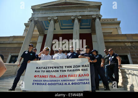 Athen, Griechenland. 6. August 2014. Gegen Entscheidungen der Regierung halten Demonstranten Stand vor dem alten Parlamentsgebäude in Athen einen Banner. Mitglieder der griechischen öffentlichen Sicherheitskräfte (Polizei-Feuerwehr-Brigade-Küstenwache) organisiert eine Demonstration gegen die griechische Regierung will ihre Renten und Sozialleistungen zu reformieren. Bildnachweis: George Panagakis/Pacific Press/Alamy Live-Nachrichten Stockfoto