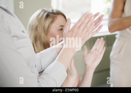 Schuss von drei Geschäftsfrauen applaudieren beschnitten Stockfoto