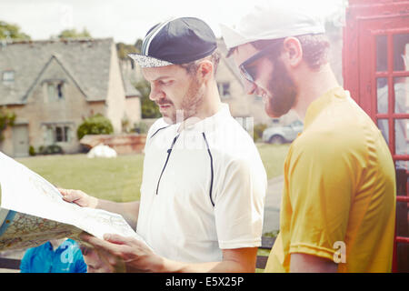 Radfahrer Kartenlesen durch rote Telefonzelle, Cotswolds, UK Stockfoto