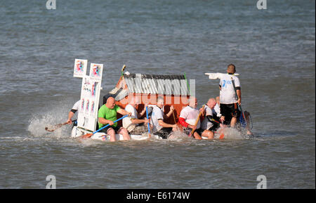 Swansea, Großbritannien. 10. August 2014. Walisischen Dichter Dylan Thomas schreiben Schuppen unter dem Motto Floß, die Teilnahme an der jährlichen RNLI murmelt Raft Race in der Nähe von Swansea. Bildnachweis: Phil Rees/Alamy Live-Nachrichten Stockfoto