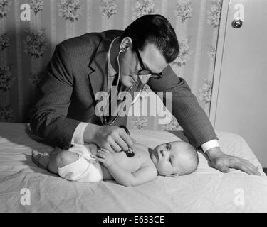 1950ER JAHREN ARZT AUF HAUSBESUCH HOLDING STETHOSKOP HERZ BABY AUF BETT LIEGEND Stockfoto