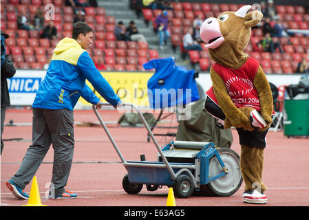 Zürich, Schweiz. 13. August 2014. Spitzenphysik «Cooly» (R) Witze mit freiwilliger bei den Europäischen Leichtathletik Weltmeisterschaften 2014 im Letzigrund Stadion in Zürich, Schweiz, 13. August 2014. Foto: Bernd Thissen/Dpa/Alamy Live News Stockfoto