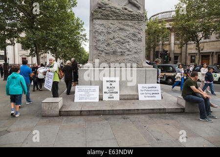 London, UK. 13. August 2014. Frauen beschreibt sich selbst als "Frauen In Schwarz gegen Militarismus und Krieg" verteile Flugblätter an Passanten am Edith Calvert Memorial in der West End von London, UK, um Unterstützung für die britische Regierung auffordern, ihren Einfluss geltend machen, um was sie beschreiben, wie die Blockade und die Aggression gegen Gaza zu beenden. Die britische Regierung kritisiert von ihrer Position im Kabinett als Minister des Auswärtigen Amtes für nicht mehr tun, um in der Ausgabe, führte zum Rücktritt der Baronin Warsi (Sayeeda Warsi) eingreifen und sie fährt fort, die Regierung zu kritisieren Stockfoto