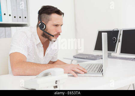 Call-Center-Agenten auf einen Aufruf an seinem Schreibtisch Stockfoto