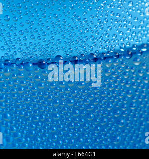 Wassertropfen auf blaue Flasche Hintergrund Stockfoto