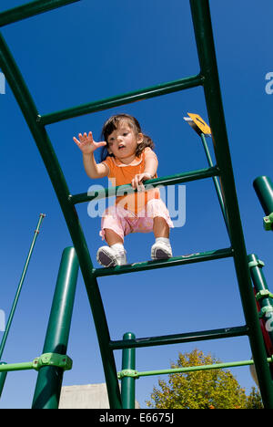 Kleinkind auf Klettergerüst klettern. Stockfoto