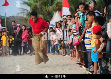 Jakarta, Indonesien. 17. August 2014. Ein indonesischer Mann beteiligt sich an einem Sackhüpfen als Teil der Independence Day feiern am Strand von Ancol in Jakarta, Indonesien, 17. August 2014. Indonesien markiert den 69. Jahrestag seiner Unabhängigkeit von der niederländischen Herrschaft am Sonntag. Bildnachweis: Zulkarnain/Xinhua/Alamy Live-Nachrichten Stockfoto